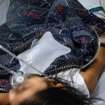 Hospital bed with patient and oxygen support- PHOTO FROM 93.5 Brigada Tacloban