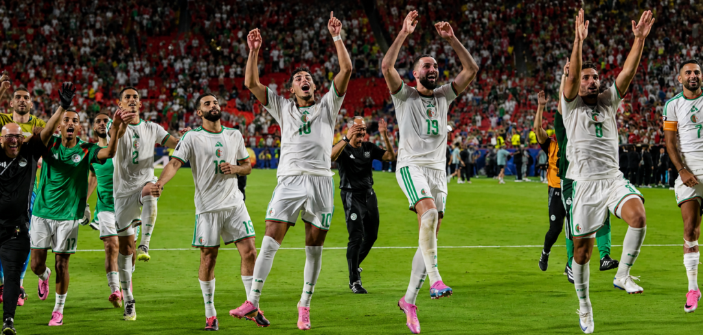 Algeria players celebrate after becoming one of the final two teams, along with Austria, to reach the Round of 32 knockout stage at the 2026 World Cup [Juan Mabromata/AFP]
