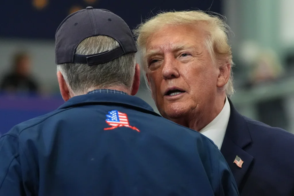 President Donald Trump talks with Sen. Dan Sullivan, R-Alaska, speaks at a campaign rally at the Curtis D. Menard Memorial Sports Center, Tuesday, Oct. 13, 2026, in Wasilla, Alaska. (AP Photo/Alex Brandon)