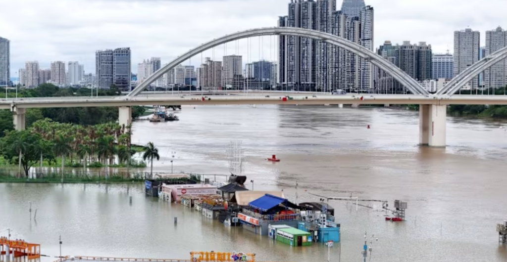 Flooded shops along a submerged riverside walk are seen by the overflowing Yongjiang river in Nanning, in China’s southern Guangxi region on Jul 7, 2026. A landslide in China's northwestern Gansu province occured on the same day, killing at least 21 people. (Photo: CN-STR via AFP)